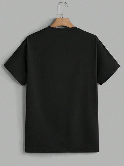Black t-shirt on a hanger against a gray background